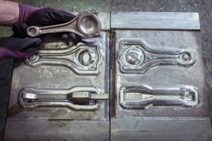 Stamping mold with blank and forged part in industrial forge