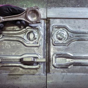 Stamping mold with blank and forged part in industrial forge